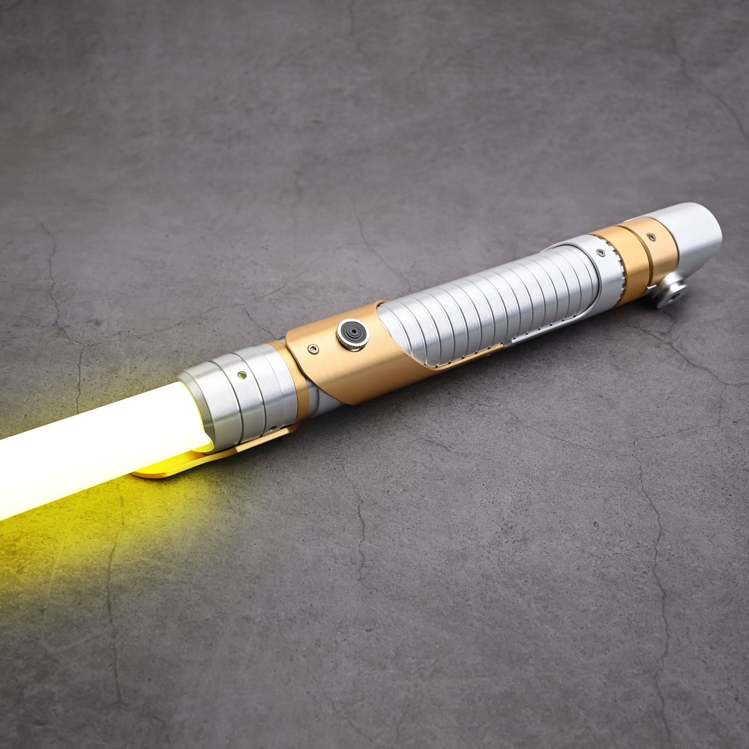 Light saber with gold and silver design on a gray surface
